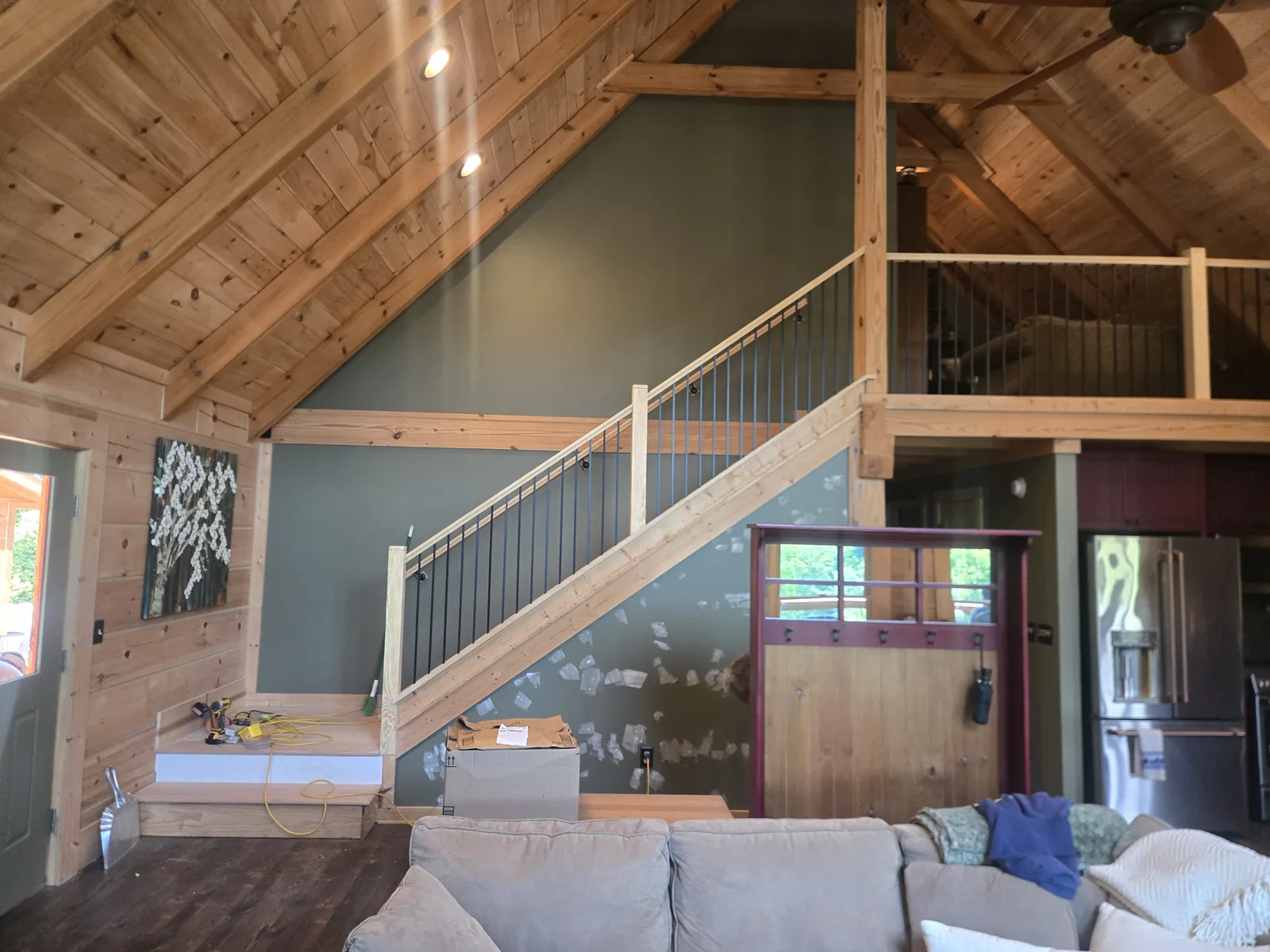 Interior loft stair railing after replacement with iron balusters