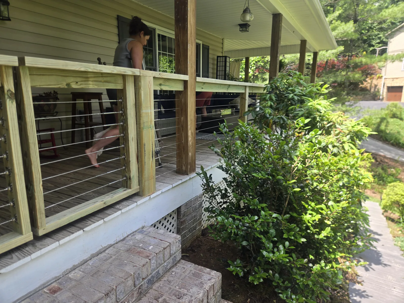 Finished exterior porch cable railing from the yard